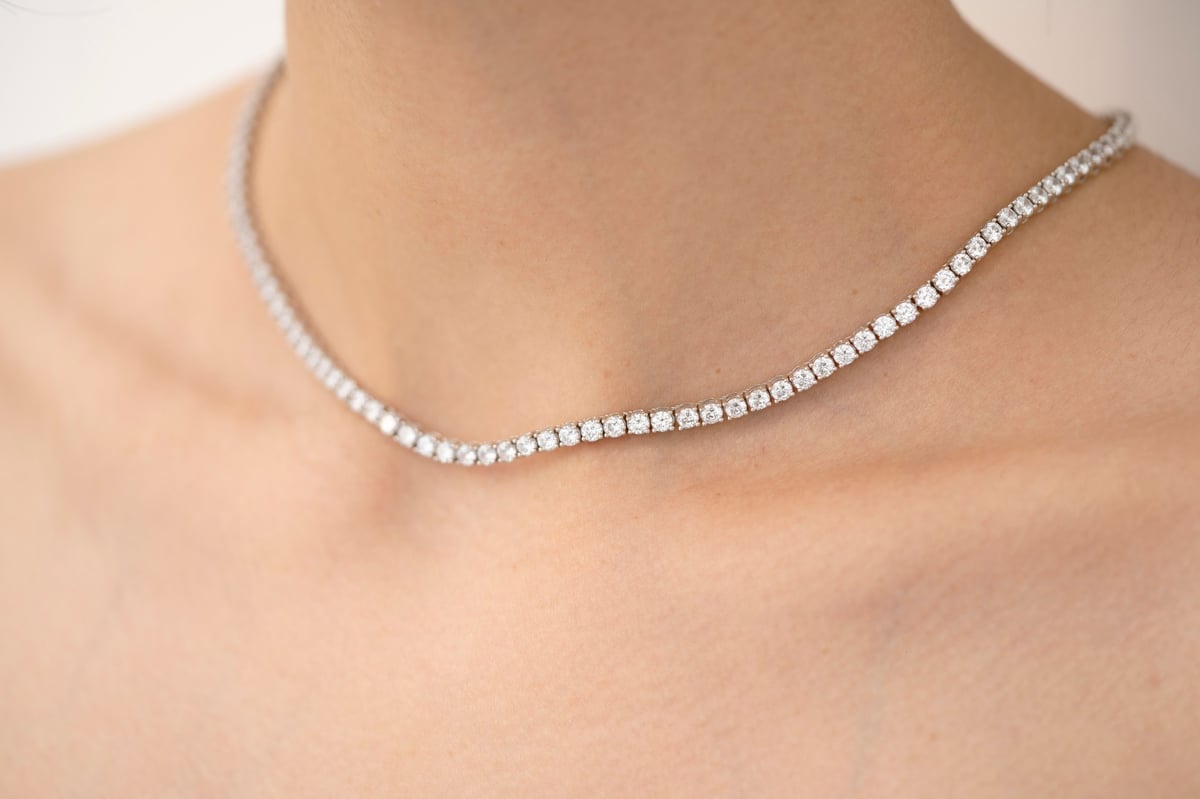 Close-up of a diamond necklace on a woman's neck, showcasing elegance and luxury in jewelry fashion