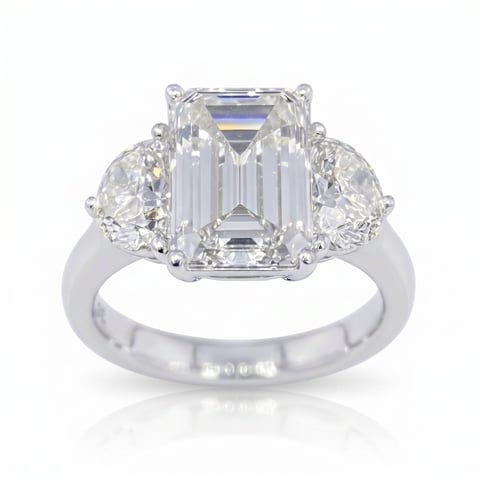 Platinum engagement ring with emerald-cut diamond center stone and pear-shaped side diamonds