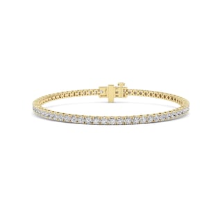 Gold tennis bracelet with diamond stones and rectangular clasp on white background