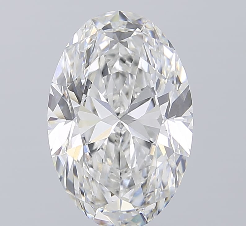 Oval cut diamond with brilliant faceting and sparkle against a light gray background