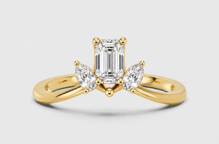 Gold engagement ring with emerald-cut center diamond and marquise side stones on white background
