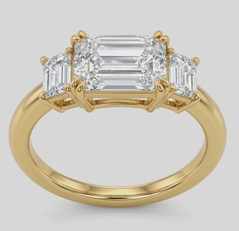 14K yellow gold three stone ring with a 1.05 CT emerald cut diamond and two 0.22 CT side diamonds