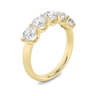 Gold wedding band with five round diamond stones arranged in an arc on a white background