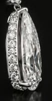 Oval diamond pendant with diamond halo setting on chain, black and white photograph