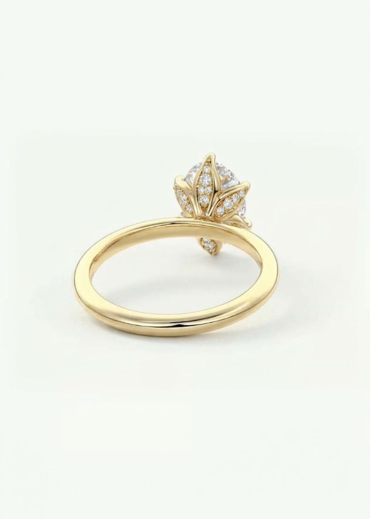 Gold engagement ring with ornate diamond crown setting on a white background