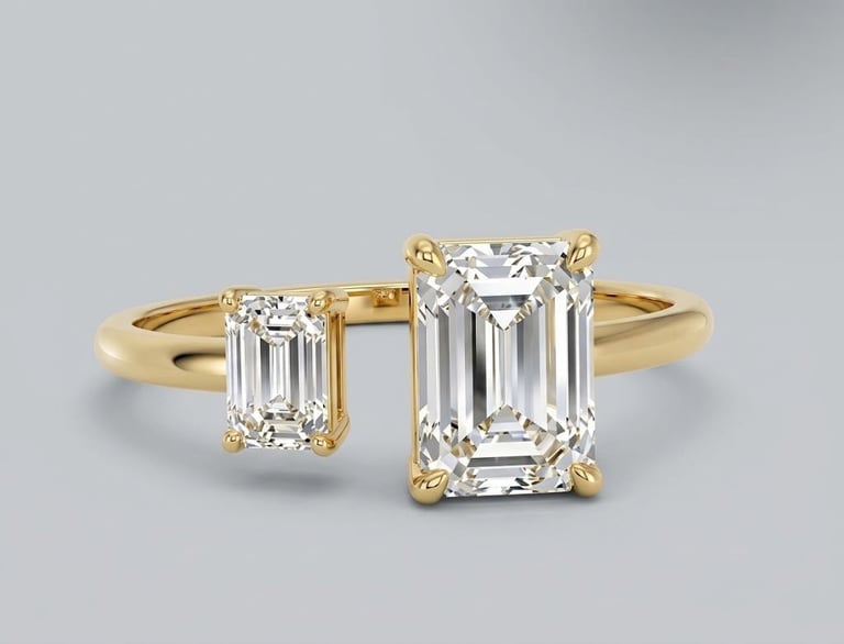 Gold engagement ring with emerald-cut diamond center stone and smaller side diamonds on gray background