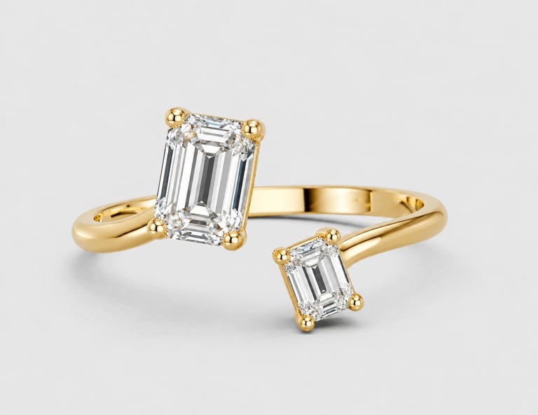Gold bypass ring with two emerald-cut diamond stones set on a light gray background