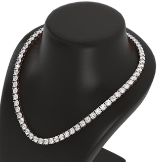 Diamond tennis necklace displayed on black mannequin bust, showcasing round brilliant-cut stones in white gold setting