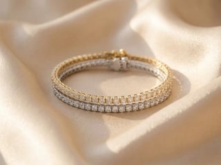 Diamond tennis bracelet with two-tone gold and silver links displayed on cream-colored fabric