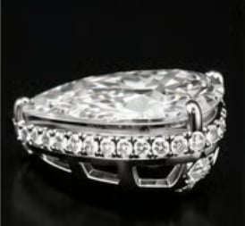 Pear-shaped diamond engagement ring with diamond-encrusted band on black background