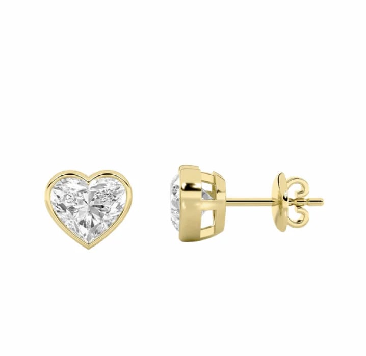 Pair of gold heart-shaped stud earrings with diamond centers, shown front and side views