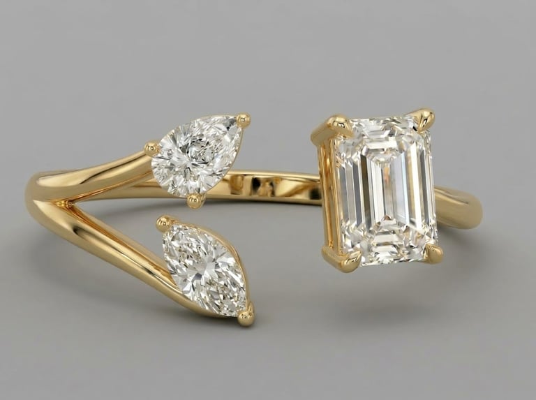 Gold engagement ring setting with multiple diamond stones including pear-shaped and emerald-cut diamonds